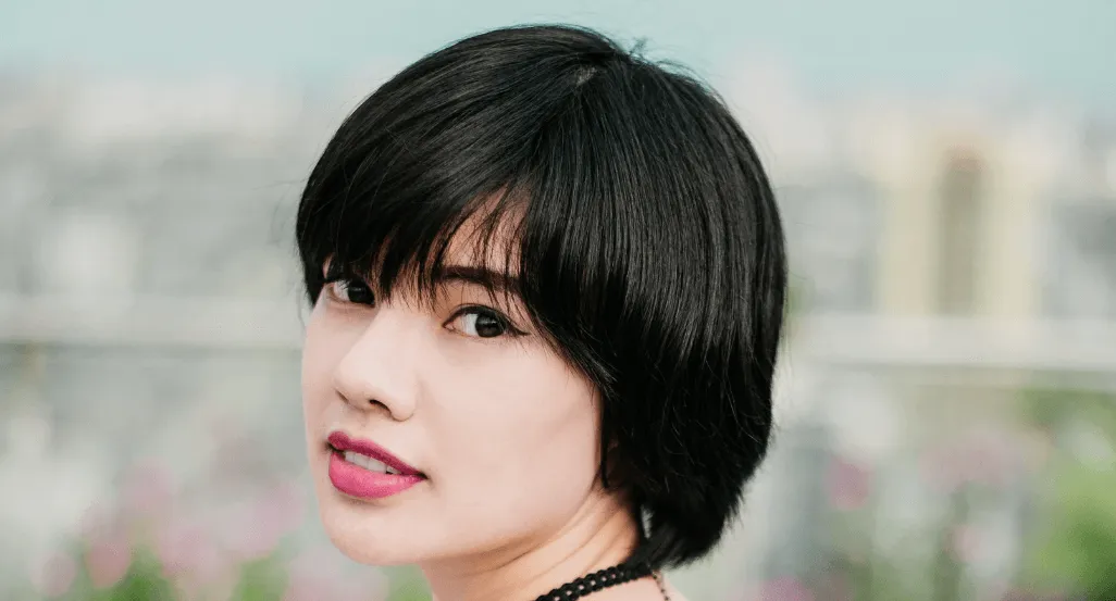 Woman with a short black bob and bangs