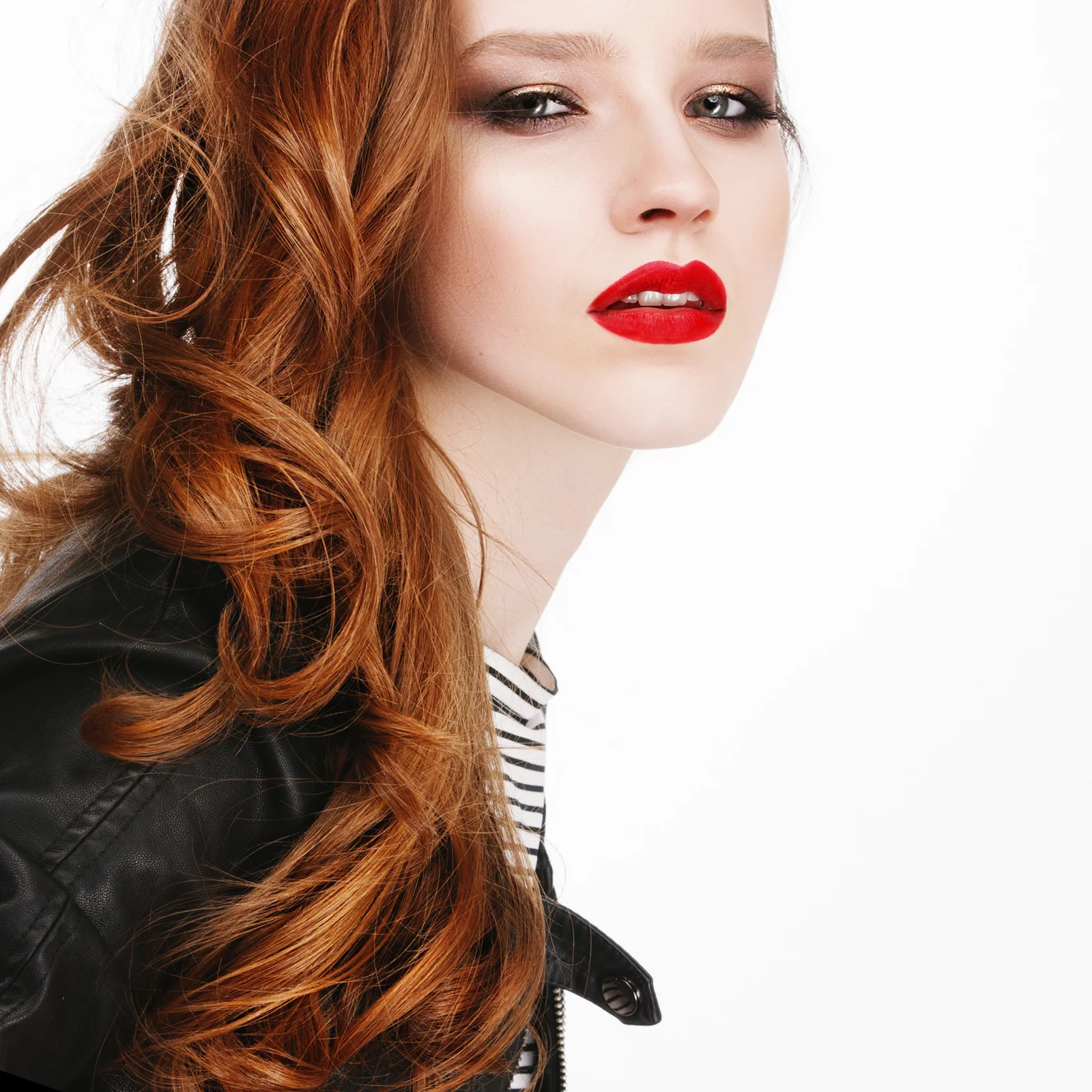 Woman with long copper-red hair swept to one side
